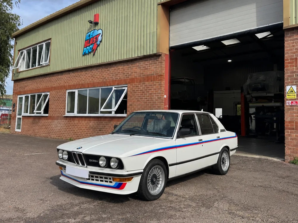 White BMW E28 535i sports saloon outside the IceBlastPro workshop