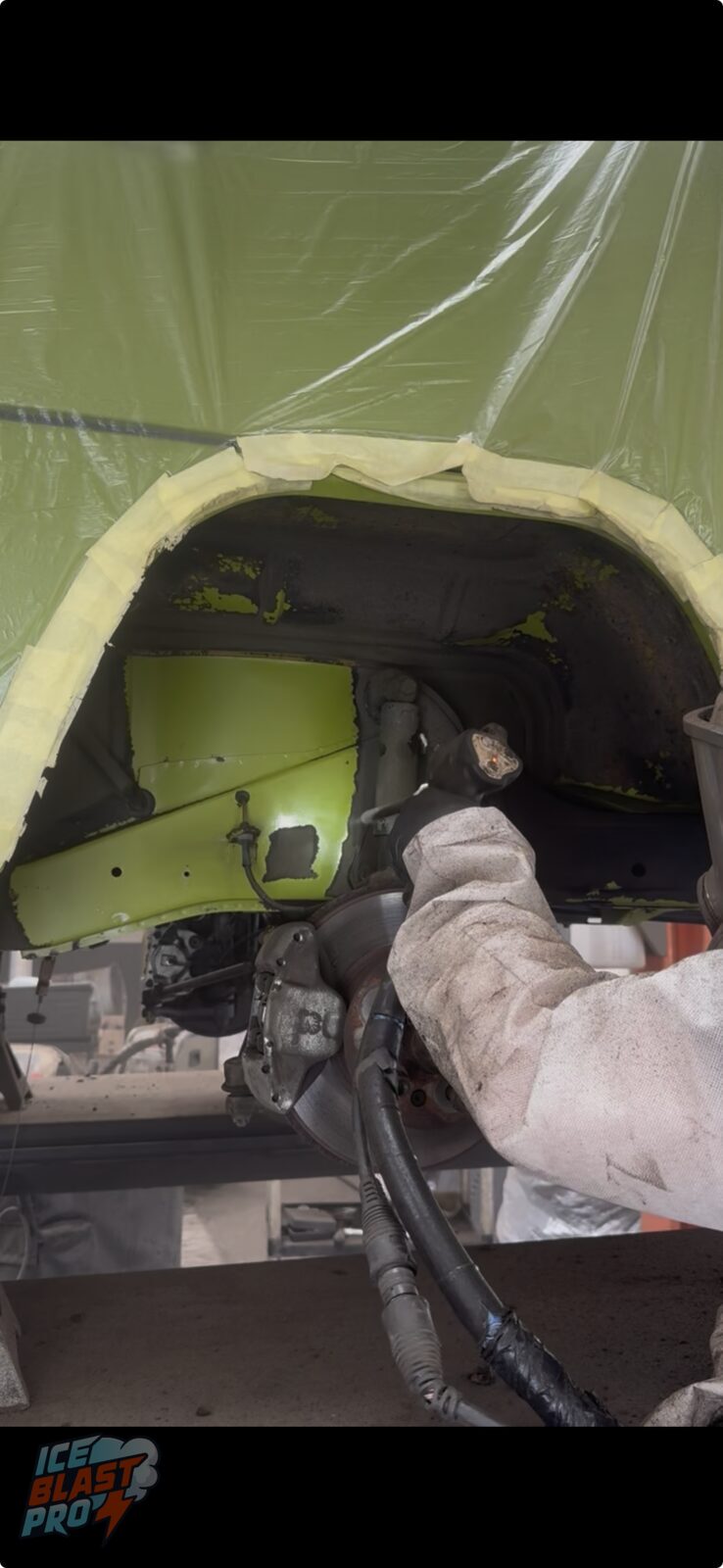 Blasting the arch – Dry ice lifting years of grime and old coating from the wheel arch, with the camper's original green paint emerging cleanly underneath.