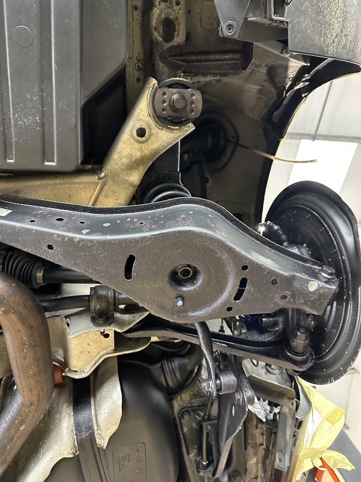 The same Golf R32 lower rear arm after dry ice blasting, rust treatment and a clear wax finish, with the surface corrosion gone and the metal sealed