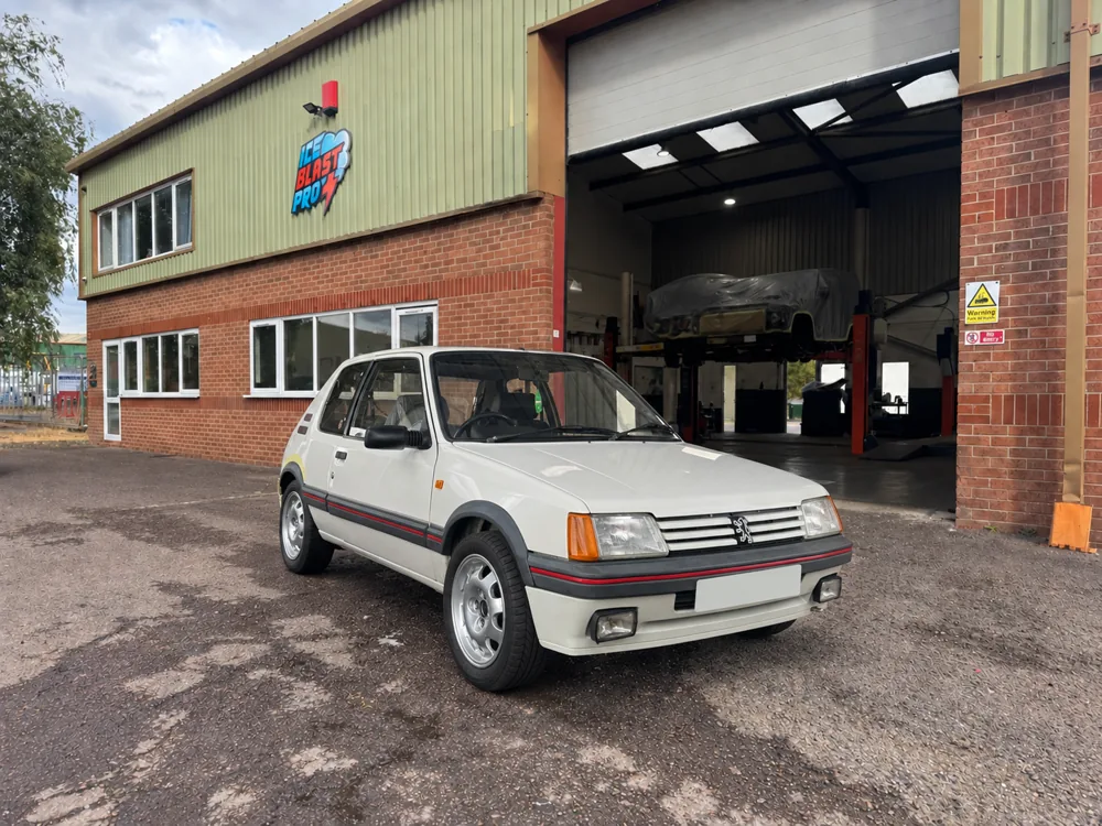 White Peugeot 205 GTI outside the IceBlastPro workshop in Oxfordshire