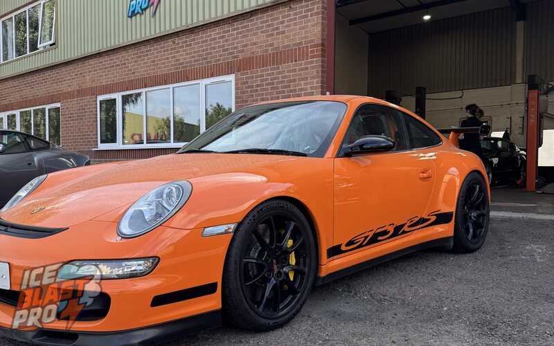 Orange Porsche 911 GT3 RS outside the IceBlastPro workshop