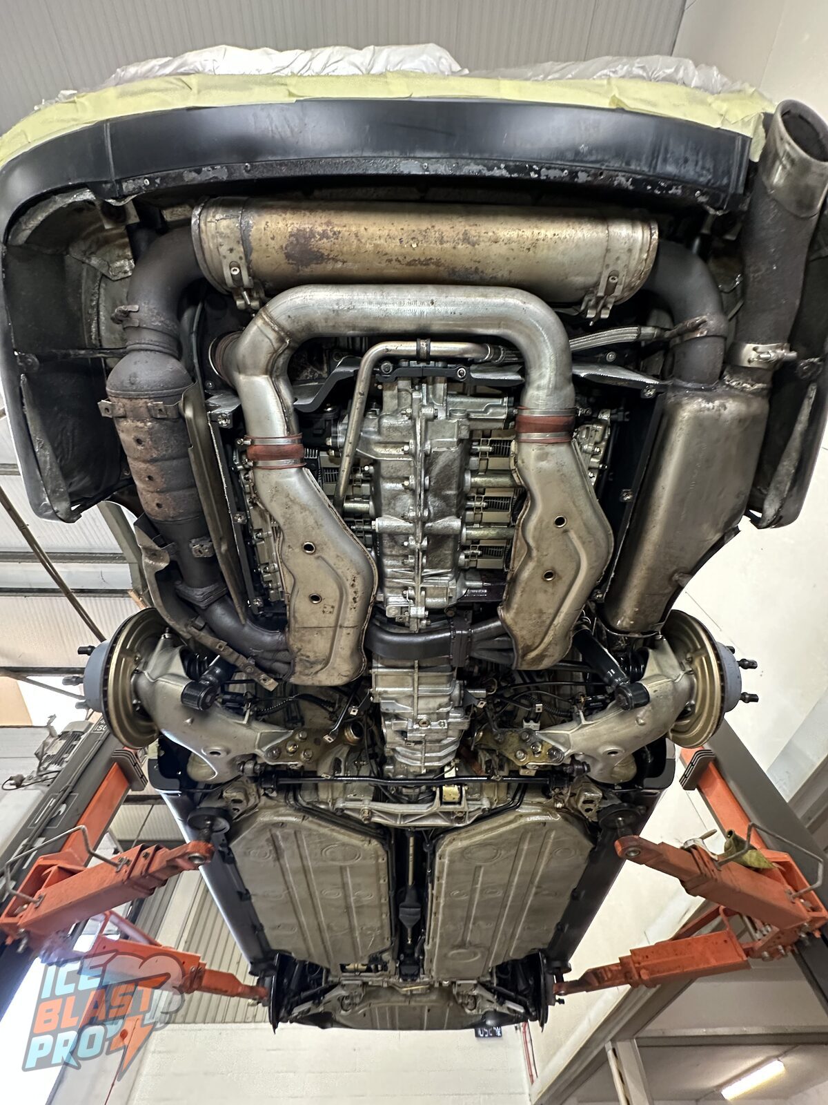 The same Porsche 911 Carrera 4 underside after dry ice blasting and Bilt Hamber Dynax UC clear protection – exhaust, alloy and floorpan cleaned and sealed