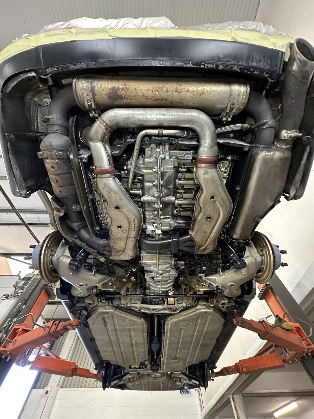 The same Porsche 911 Carrera 4 underside after dry ice blasting and Bilt Hamber Dynax UC clear protection – exhaust, alloy and floorpan cleaned and sealed