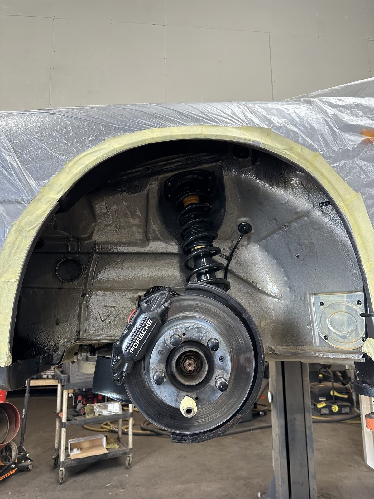 The same Porsche 911 Carrera 4 wheel arch after dry ice cleaning – spring, caliper and inner arch cleaned back and clear-protected