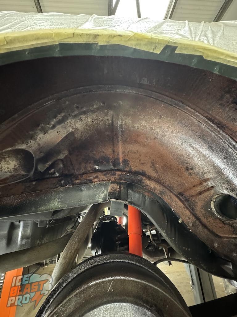 Beneath the underseal – Pitted metal, red oxide and deep-set corrosion across the arches – exactly the kind of damage that turns to rot if left another year or two.