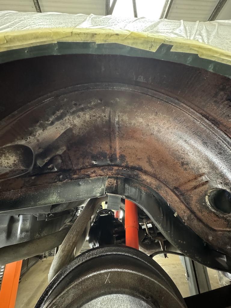 Beneath the underseal – Pitted metal, red oxide and deep-set corrosion across the arches – exactly the kind of damage that turns to rot if left another year or two.