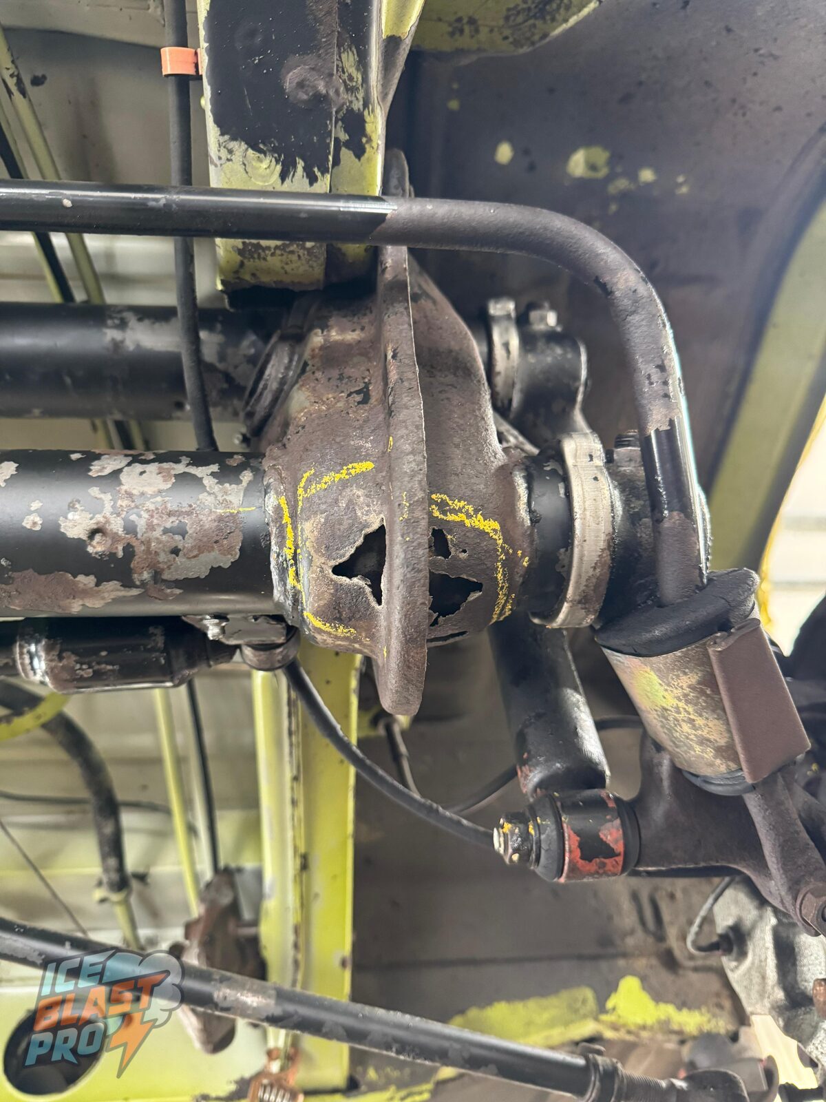 Corrosion through the beam – With the grime gone, corrosion had eaten right through the metal – marked up so it could be discussed and repaired rather than coated over.