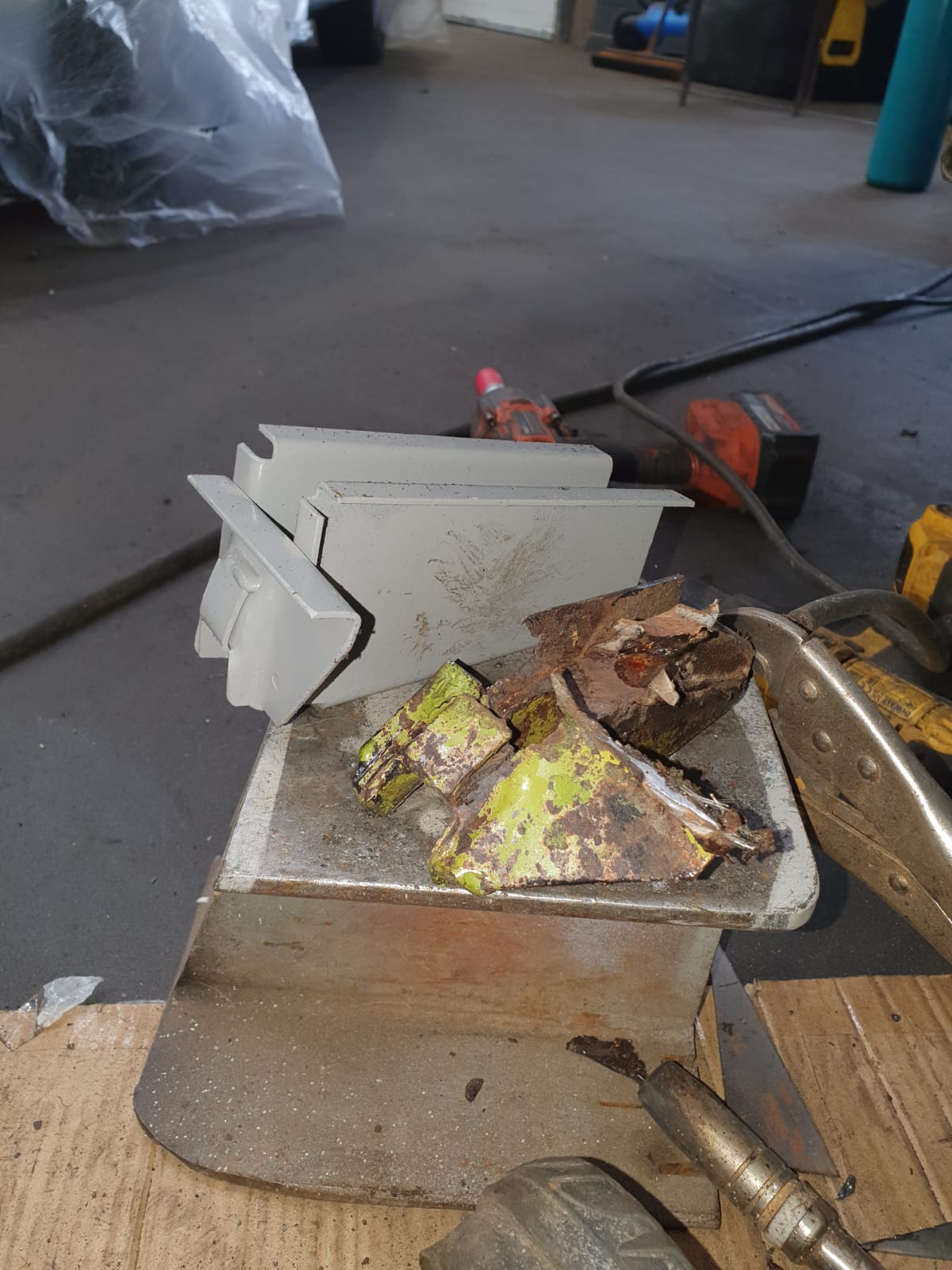 New jacking point sections – New jacking point sections fabricated to replace the rotten originals, shown alongside the corroded metal that was cut away.