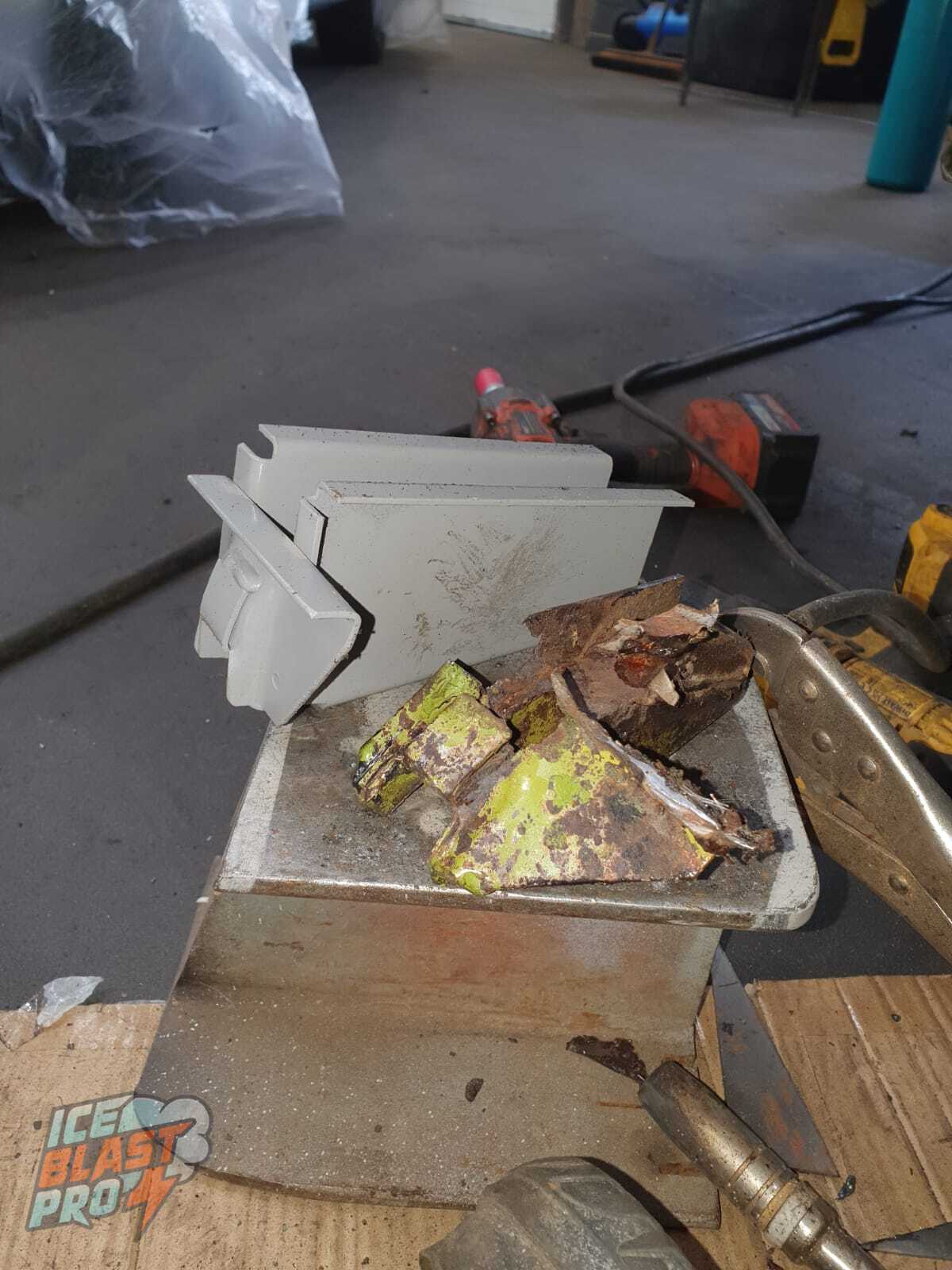 New jacking point sections – New jacking point sections fabricated to replace the rotten originals, shown alongside the corroded metal that was cut away.