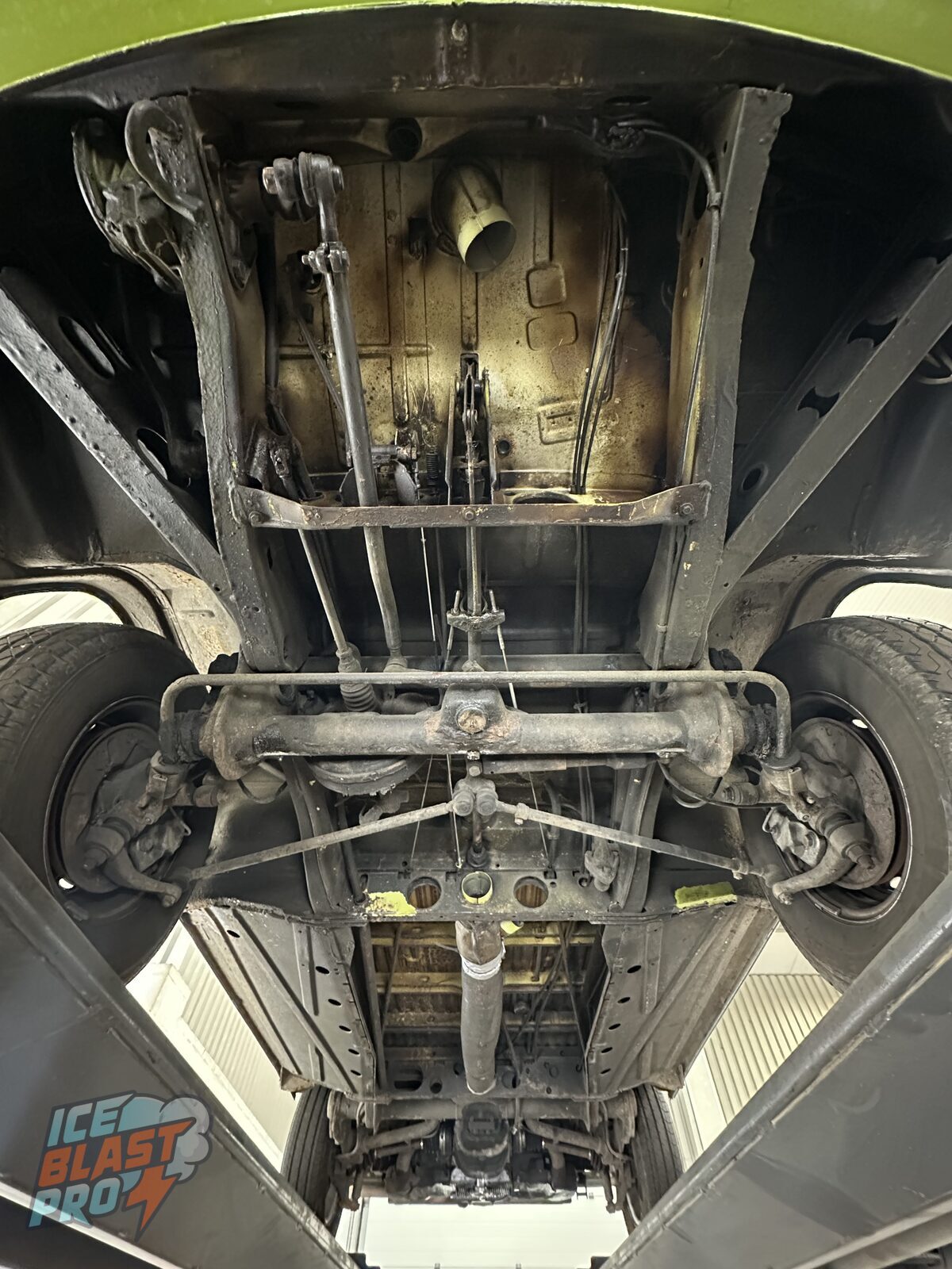 Full underbody – Decades of road grime, old underseal and surface corrosion across the floor pans, chassis members and running gear – the underside of a camper that has earned its keep.