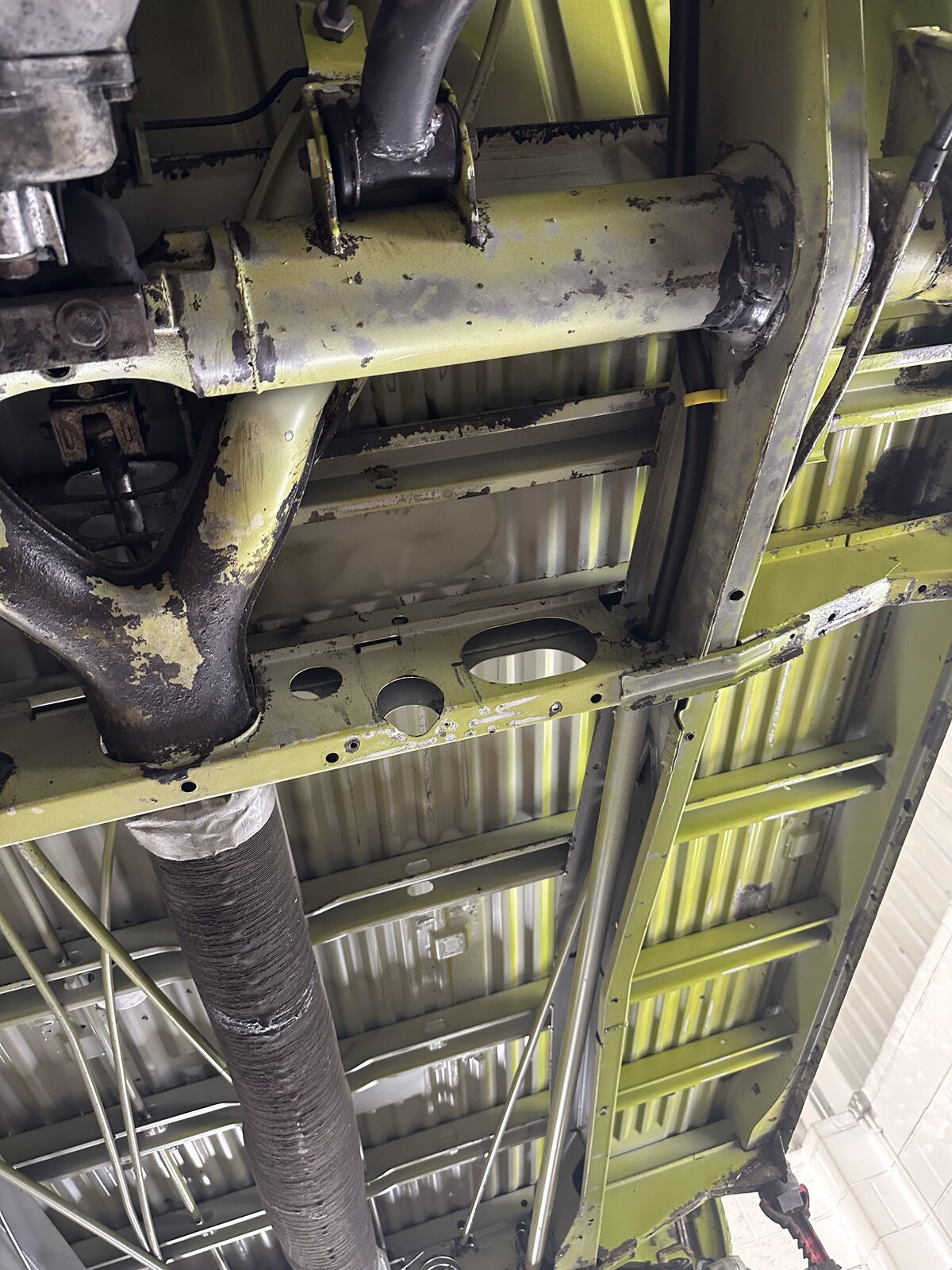 Floor sections treated – The ribbed floor pans after rust conversion, with the metal stabilised and a sound foundation laid before any protective coating.
