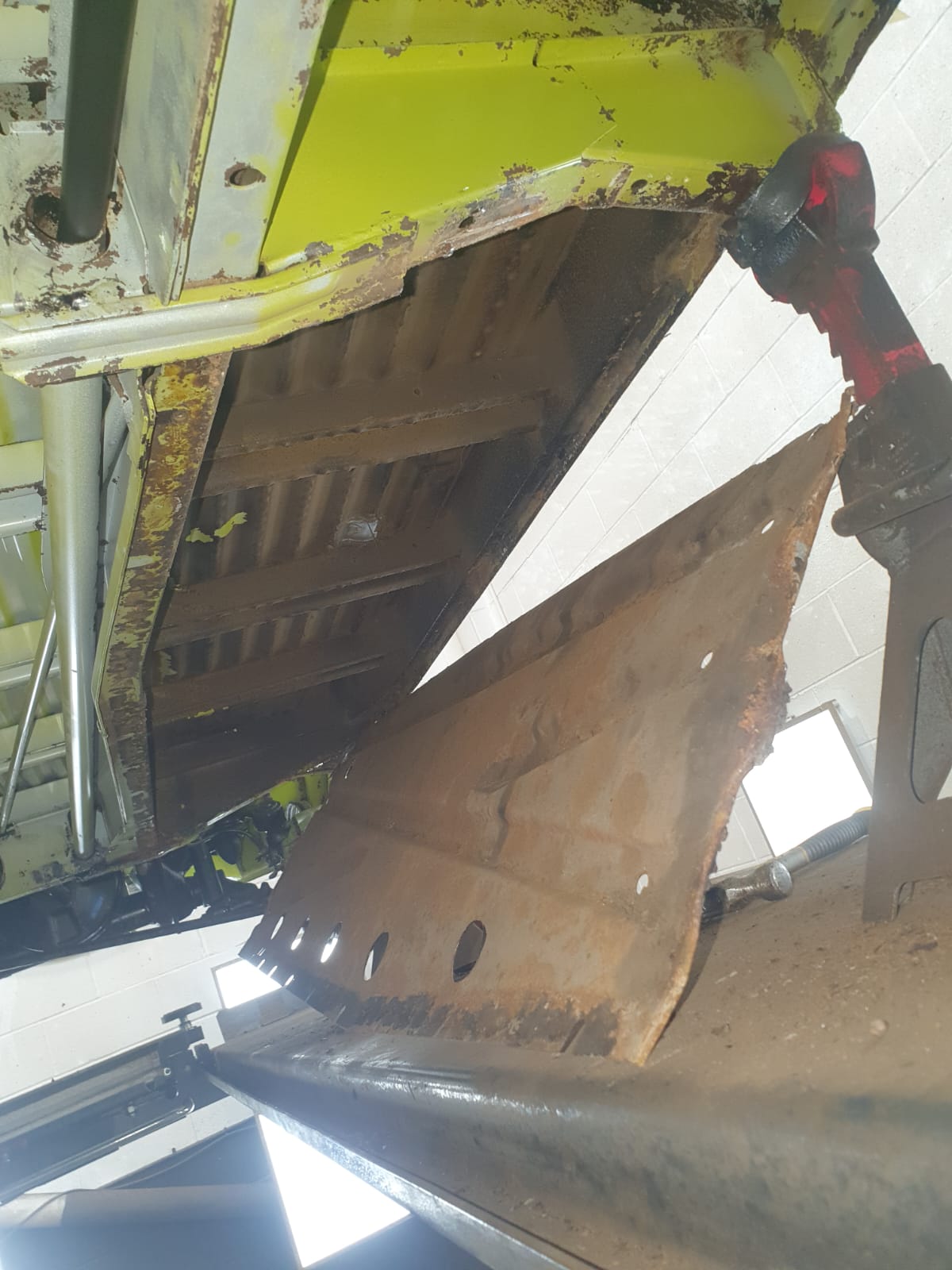Undertray removed – A corroded, welded-on tray taken off to reach the metal behind it – the kind of trapped area where moisture sits unseen and rust takes hold.
