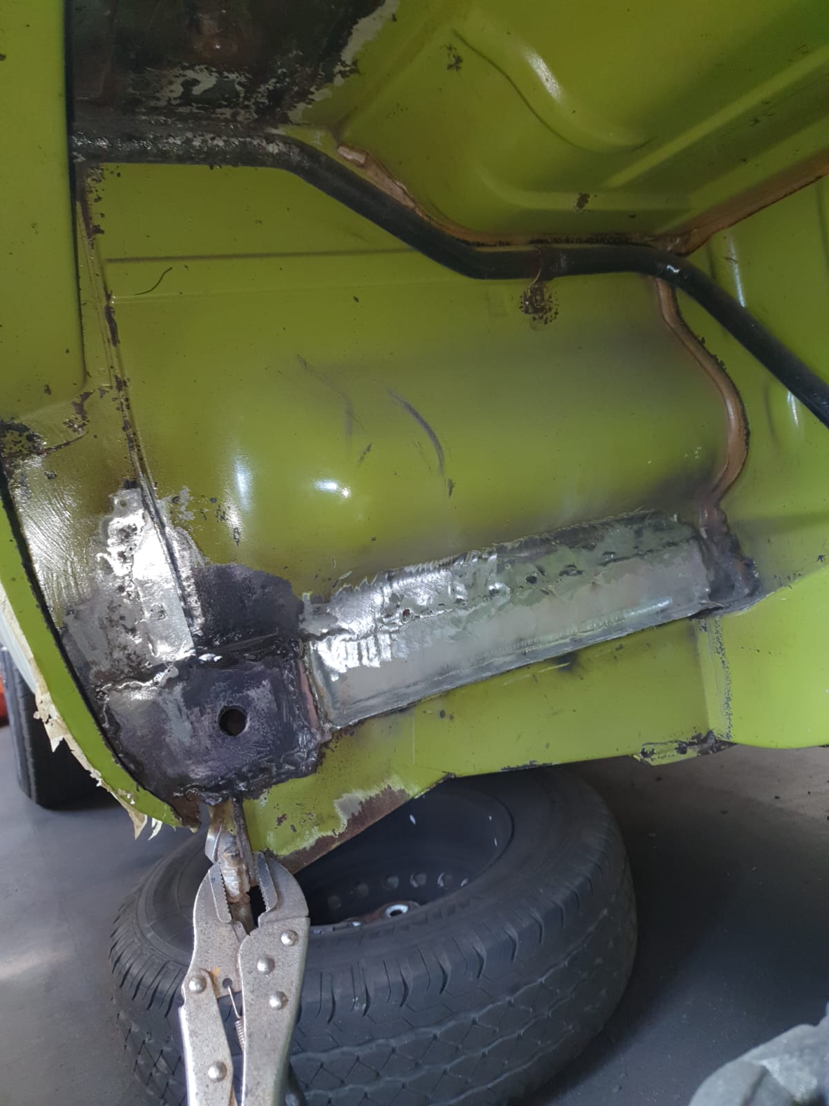 Welding in fresh metal – The corroded section cut back to sound steel and new metal welded in – a proper structural repair in place of the failed fibreglass.
